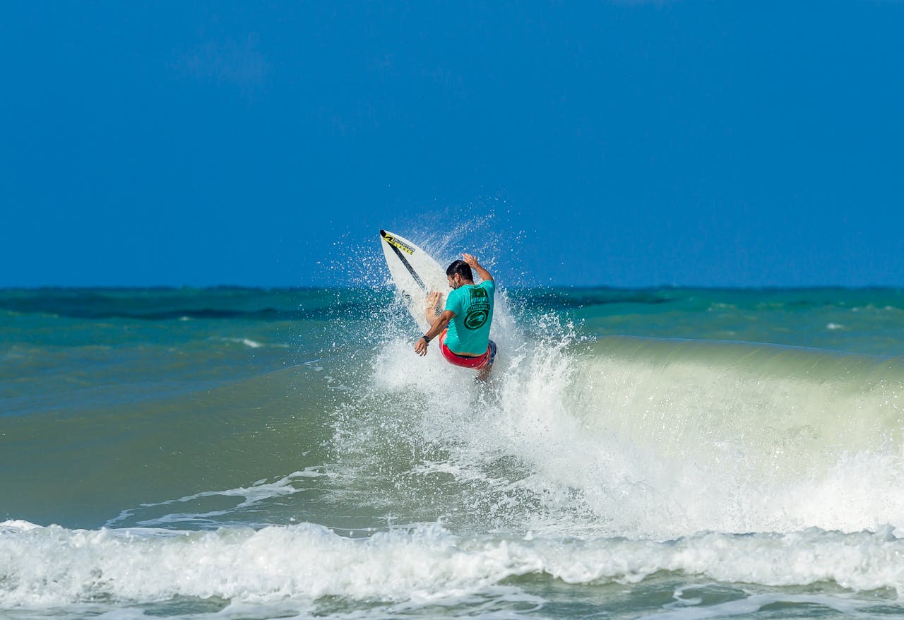 Dynamic shot of a surfer catching waves at Tibau do Sul, Brazil.