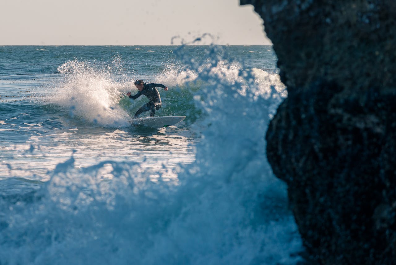 Thrilling shot of a surfer expertly navigating powerful ocean waves. Perfect for adventure and sports themes.